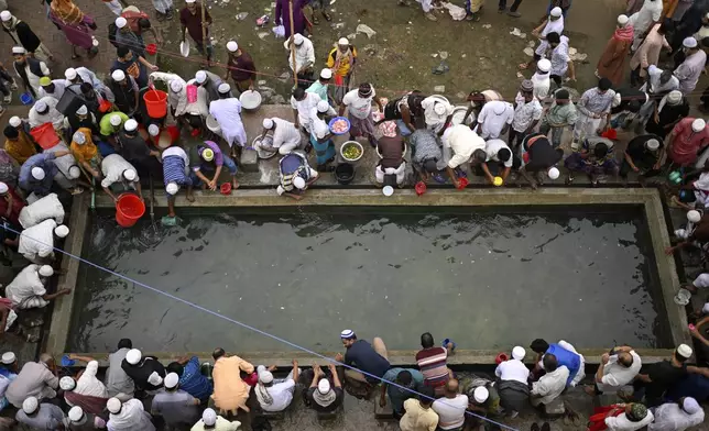 Muslim devotees perform ablutions before prayers during the first phase of the three-day Biswa Ijtema, or the World Congregation of Muslims, at the banks of the Turag river in Tongi, near Dhaka, Bangladesh, Friday, Jan. 31, 2025. (AP Photo/Mahmud Hossain Opu)
