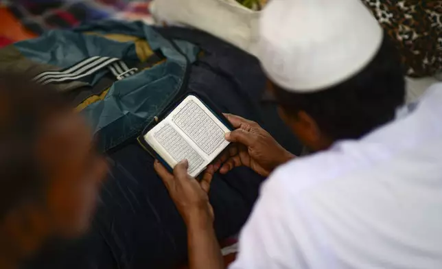 A Muslim devotee reads the Holy Quran in a tent during the first phase of the three-day Biswa Ijtema, or the World Congregation of Muslims, at the banks of the Turag river in Tongi, near Dhaka, Bangladesh, Friday, Jan. 31, 2025. (AP Photo/Mahmud Hossain Opu)