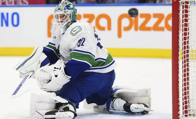 Vancouver Canucks goaltender Kevin Lankinen (32) makes a save against the Toronto Maple Leafs during second period NHL hockey action in Toronto on Saturday, Jan. 11, 2025. (Frank Gunn/The Canadian Press via AP)