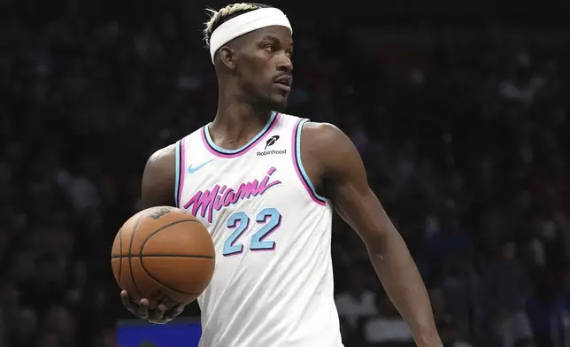 Miami Heat forward Jimmy Butler looks to pass the ball during the first half of an NBA basketball game against the Denver Nuggets, Friday, Jan. 17, 2025, in Miami. (AP Photo/Lynne Sladky)