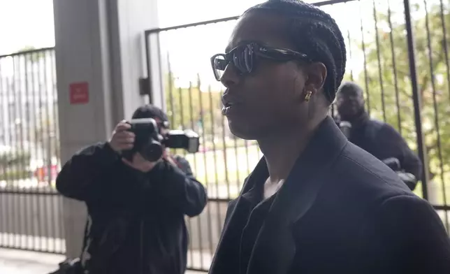 Grammy-nominated rapper A$AP Rocky, center, facing two felony counts of assault with a semiautomatic firearm after allegedly shooting at a former friend in 2021, arrives at the Clara Shortridge Foltz Criminal Justice Center in Los Angeles, Wednesday, Jan. 22, 2025. (AP Photo/Damian Dovarganes)