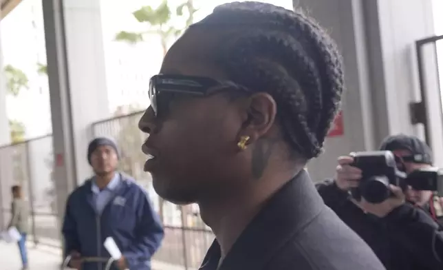 Grammy-nominated rapper A$AP Rocky, center, facing two felony counts of assault with a semiautomatic firearm after allegedly shooting at a former friend in 2021, arrives at the Clara Shortridge Foltz Criminal Justice Center in Los Angeles, Wednesday, Jan. 22, 2025. (AP Photo/Damian Dovarganes)