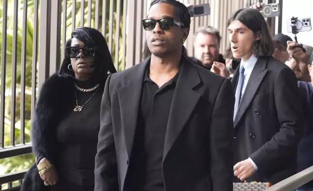 Grammy-nominated rapper A$AP Rocky, center, facing two felony counts of assault with a semiautomatic firearm after allegedly shooting at a former friend in 2021, arrives at the Clara Shortridge Foltz Criminal Justice Center in Los Angeles, Wednesday, Jan. 22, 2025. (AP Photo/Damian Dovarganes)