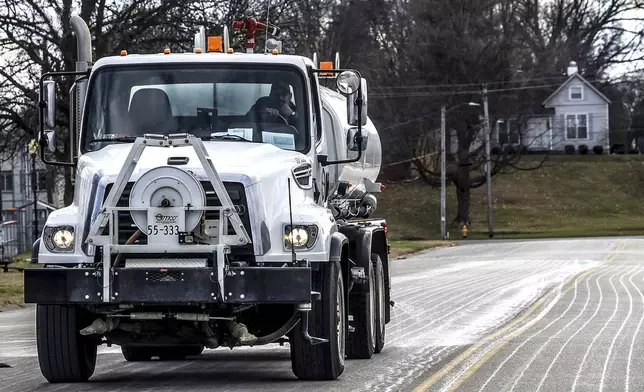 FILE - Steve Beckett with the street department in Owensboro, Ky., sprays a salt brine solution along Hickman Avenue in preparation for predicted snow and ice over the weekend, Friday, Jan. 3, 2025, in Owensboro, Ky. (Greg Eans/The Messenger-Inquirer via AP, File)