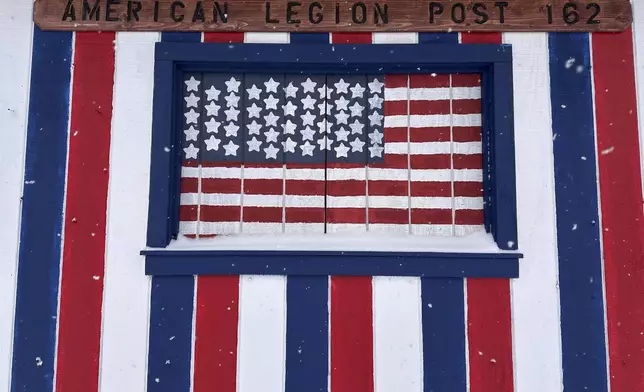 More snow falls near the American Legion Post in Lowville, N.Y., Sunday, Jan. 5, 2025. (AP Photo/Cara Anna)