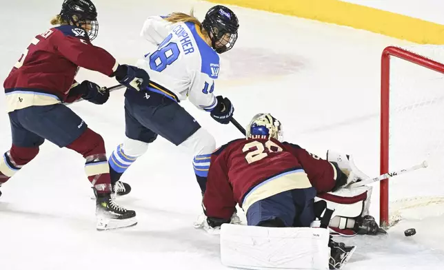 Toronto Sceptres' Jesse Compher (18) scores against Montreal Victoire goaltender Elaine Chuli (20) as Victoire's Anna Wilgren (5) defends during first-period PWHL hockey game action in Laval, Quebec, Thursday, Jan. 30, 2025. (Graham Hughes/The Canadian Press via AP)