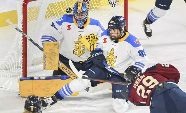 Montreal Victoire's Marie-Philip Poulin (29) shoots against Toronto Sceptres goaltender Kristen Campbell, top left, as Sceptres' Sarah Nurse (20) defends during first-period PWHL hockey game action in Laval, Quebec, Thursday, Jan. 30, 2025. (Graham Hughes/The Canadian Press via AP)