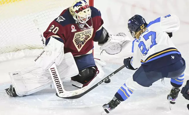 Toronto Sceptres' Emma Maltais (27) moves in against Montreal Victoire goaltender Elaine Chuli during second-period PWHL hockey game action in Laval, Quebec, Thursday, Jan. 30, 2025. (Graham Hughes/The Canadian Press via AP)