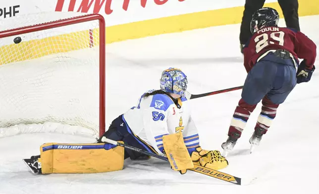 Montreal Victoire's Marie-Philip Poulin (29) scores against Toronto Sceptres goaltender Kristen Campbell, left, during shootout PWHL hockey game action in Laval, Quebec, Thursday, Jan. 30, 2025. (Graham Hughes/The Canadian Press via AP)
