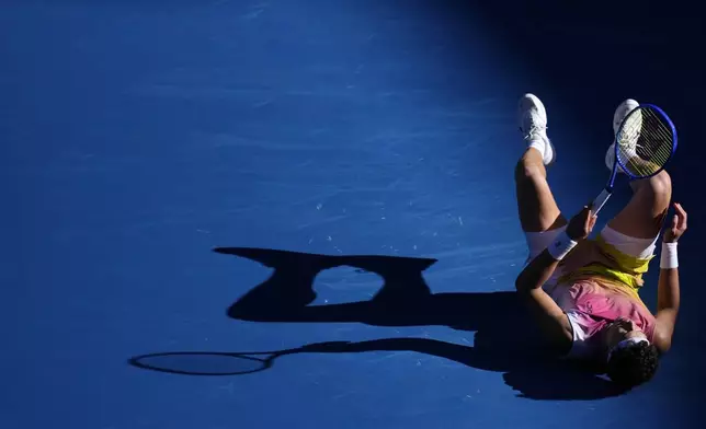 Ben Shelton of the U.S. falls during his quarterfinal match against Lorenzo Sonego of Italy at the Australian Open tennis championship in Melbourne, Australia, Wednesday, Jan. 22, 2025. (AP Photo/Vincent Thian)