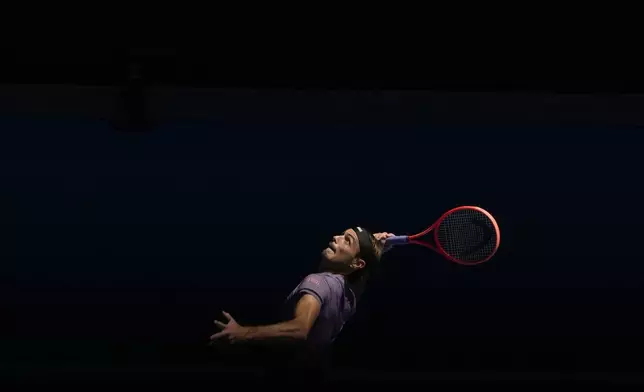Taylor Fritz of the U.S. serves to Gael Monfils of France during their third round match at the Australian Open tennis championship in Melbourne, Australia, Saturday, Jan. 18, 2025. (AP Photo/Manish Swarup)