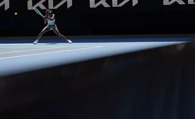 Coco Gauff of the U.S. returns a shot from Belinda Bencic of Switzerland during their fourth round match at the Australian Open tennis championship in Melbourne, Australia, Sunday, Jan. 19, 2025. (AP Photo/Asanka Brendon Ratnayake)