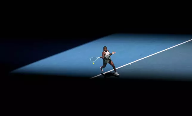 Coco Gauff of the U.S. plays a forehand return to Paula Badosa of Spain during their quarterfinal match at the Australian Open tennis championship in Melbourne, Australia, Tuesday, Jan. 21, 2025. (AP Photo/Asanka Brendon Ratnayake)