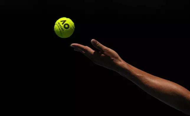 Iga Swiatek of Poland serves to Emma Navarro of the U.S. during their quarterfinal match at the Australian Open tennis championship in Melbourne, Australia, Wednesday, Jan. 22, 2025. (AP Photo/Asanka Brendon Ratnayake)