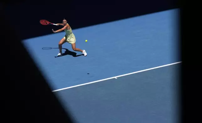 Emma Navarro of the U.S. plays a forehand return to Ons Jabeur of Tunisia during their third round match at the Australian Open tennis championship in Melbourne, Australia, Saturday, Jan. 18, 2025. (AP Photo/Manish Swarup)