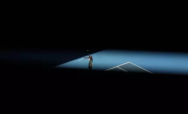 Coco Gauff of the U.S. serves to Paula Badosa of Spain during their quarterfinal match at the Australian Open tennis championship in Melbourne, Australia, Tuesday, Jan. 21, 2025. (AP Photo/Asanka Brendon Ratnayake)