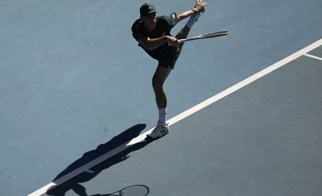 Tommy Paul of the U.S. plays a forehand return to Alexander Zverev of Germany during their quarterfinal match at the Australian Open tennis championship in Melbourne, Australia, Tuesday, Jan. 21, 2025. (AP Photo/Ng Han Guan)