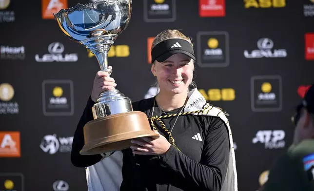 Clara Tauson of Denmark poses with trophy after Naomi Osaka of Japan withdrew from the women's singles final match of the ASB Classic tennis tournament at Manuka Doctor Arena in Auckland, New Zealand Sunday, Jan. 5, 2025. (Alan Lee/Photosport via AP)