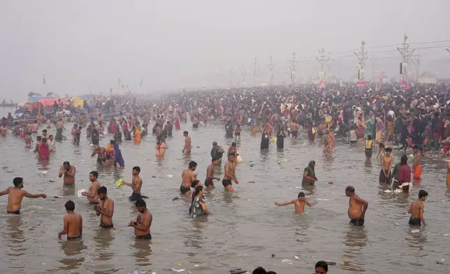Hindu devotees take a holy dip in the Sangam, the confluence of the Ganges, the Yamuna and the mythical Saraswati rivers, on "Mauni Amavasya" or new moon day during the Maha Kumbh festival in Prayagraj, India, Wednesday, Jan. 29, 2025. (AP Photo/Deepak Sharma)