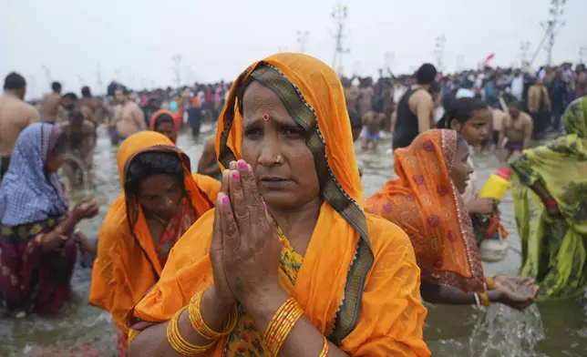 Hindu devotees pray after taking a holy dip in the Sangam, the confluence of the Ganges, the Yamuna and the mythical Saraswati rivers, on "Mauni Amavasya" or new moon day during the Maha Kumbh festival in Prayagraj, India, Wednesday, Jan. 29, 2025. (AP Photo/Deepak Sharma)