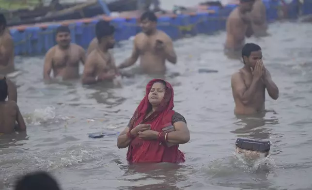 A Hindu devotee takes a holy dip on the banks of the Sangam, the confluence of the Ganges, the Yamuna and the mythical Saraswati rivers, on "Mauni Amavasya" or new moon day during the Maha Kumbh festival in Prayagraj, Uttar Pradesh, India, Wednesday, Jan. 29, 2025. (AP Photo/Deepak Sharma)