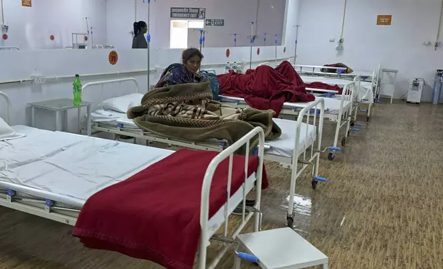 A woman who was injured in a stampede when Hindu devotees rushed to take a holy bath in the Sangam, the confluence of the Ganges, the Yamuna and the mythical Saraswati rivers, during the Maha Kumbh festival, receives treatment at a hospital in Prayagraj, India, Wednesday, Jan. 29, 2025. (AP Photo/Rajesh Kumar Singh)