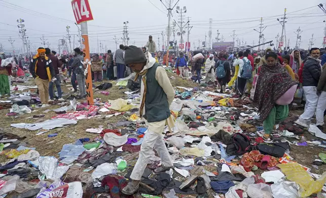 Hindu devotees search for their belongings after a stampede when Hindu devotees rushed to take a holy bath in the Sangam, the confluence of the Ganges, the Yamuna and the mythical Saraswati rivers, on "Mauni Amavasya" or new moon day during the Maha Kumbh festival in Prayagraj, India, Wednesday, Jan. 29, 2025. (AP Photo/Deepak Sharma)