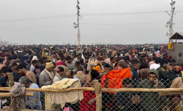 Hindu devotees gather to take a holy dip in the Sangam, the confluence of the Ganges, the Yamuna and the mythical Saraswati rivers, on "Mauni Amavasya" or new moon day during the Maha Kumbh festival in Prayagraj, India, Wednesday, Jan. 29, 2025. (AP Photo/Rajesh Kumar Singh)