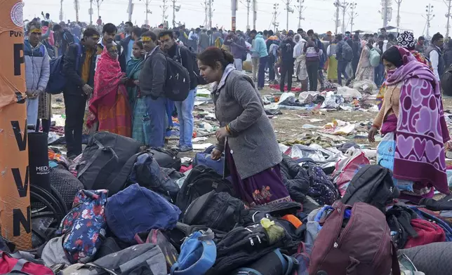 Hindu devotees search for their belongings after a stampede when Hindu devotees rushed to take a holy bath in the Sangam, the confluence of the Ganges, the Yamuna and the mythical Saraswati rivers, on "Mauni Amavasya" or new moon day during the Maha Kumbh festival in Prayagraj, India, Wednesday, Jan. 29, 2025. (AP Photo/Deepak Sharma)