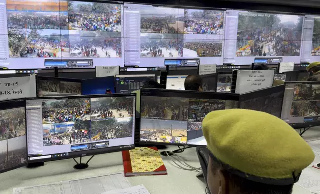 A police official monitors the movement of people at the control room after a stampede when Hindu devotees rushed to take a holy bath in the Sangam, the confluence of the Ganges, the Yamuna and the mythical Saraswati rivers, on "Mauni Amavasya" or new moon day during the Maha Kumbh festival in Prayagraj, India, Wednesday, Jan. 29, 2025. (AP Photo/Rajesh Kumar Singh)