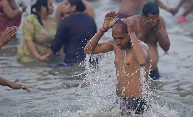 Hindu devotees take a holy dip in the Sangam, the confluence of the Ganges, the Yamuna and the mythical Saraswati rivers, on "Mauni Amavasya" or new moon day during the Maha Kumbh festival in Prayagraj, India, Wednesday, Jan. 29, 2025. (AP Photo/Deepak Sharma)
