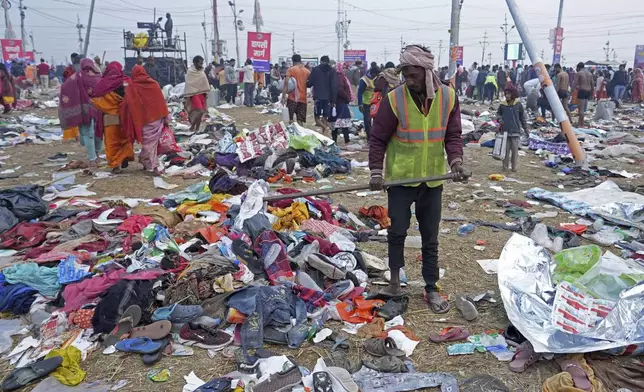 A volunteer helps people to look for their valuables after a stampede when Hindu devotees rushed to take a holy bath in the Sangam, the confluence of the Ganges, the Yamuna and the mythical Saraswati rivers, on "Mauni Amavasya" or new moon day during the Maha Kumbh festival in Prayagraj, India, Wednesday, Jan. 29, 2025. (AP Photo/Deepak Sharma)