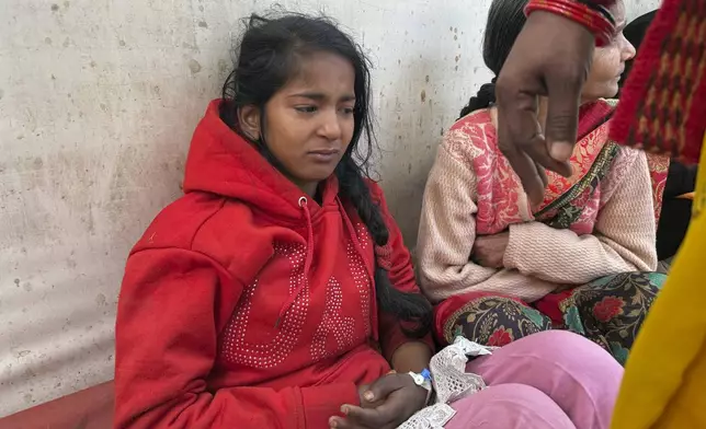 An injured girl reacts as she is being treated at a hospital after a stampede when Hindu devotees rushed to take a holy bath in the Sangam, the confluence of the Ganges, the Yamuna and the mythical Saraswati rivers, during the Maha Kumbh festival, in Prayagraj, India, Wednesday, Jan. 29, 2025. (AP Photo/Rajesh Kumar Singh)
