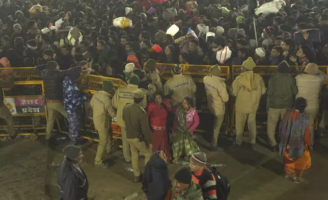 Hindu devotees speak with a policeman at the site of a stampede on the Sangam, the confluence of the Ganges, the Yamuna and the mythical Saraswati rivers, on "Mauni Amavasya" or new moon day during the Maha Kumbh festival, in Prayagraj, Uttar Pradesh, India, Wednesday, Jan. 29, 2025. (AP Photo)