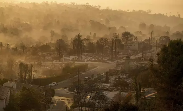 The devastation of the Palisades Fire is seen in the early morning in the Pacific Palisades neighborhood of Los Angeles, Friday, Jan. 10, 2025. (AP Photo/John Locher)
