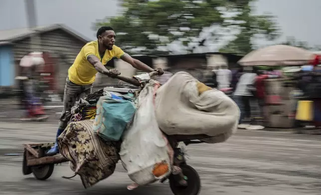 People displaced by the fighting with M23 rebels make their way to the center of Goma, Democratic Republic of the Congo, Sunday, Jan. 26, 2025. (AP Photo/Moses Sawasawa)