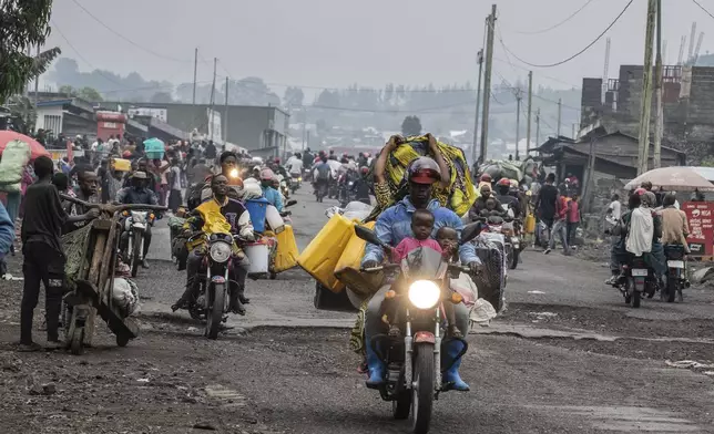 People displaced by the fighting with M23 rebels make their way to the center of Goma, Democratic Republic of the Congo, Sunday, Jan. 26, 2025. (AP Photo/Moses Sawasawa)