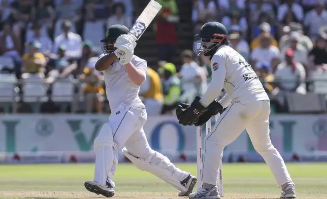 South Africa's Temba Bavuma, left, plays a shot while Pakistan's Mohammad Rizwan looks on during the second test match between South Africa and Pakistan in Cape Town, South Africa, Friday, Jan. 3, 2025. (AP Photo/Halden Krog)