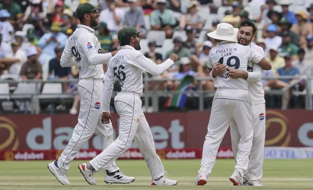 Pakistan players celebrate the wicket of South African batsman Tristan Stubbs during the second test match between South Africa and Pakistan in Cape Town, South Africa, Friday, Jan. 3, 2025. (AP Photo/Halden Krog)