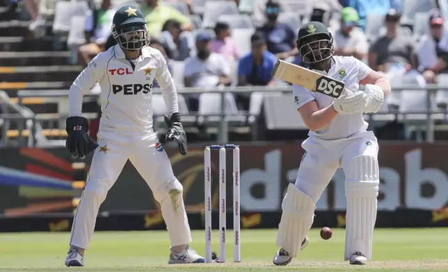 South Africa's Temba Bavuma, right, plays a shot while Pakistan's Mohammad Rizwan watches on during the second test match between South Africa and Pakistan in Cape Town, South Africa, Friday, Jan. 3, 2025. (AP Photo/Halden Krog)