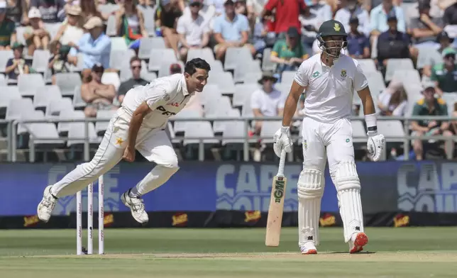 Pakistan bowler Mohammad Abbas in action while South Africa's Aiden Markram looks on during the second test match between South Africa and Pakistan in Cape Town, South Africa, Friday, Jan. 3, 2025. (AP Photo/Halden Krog)