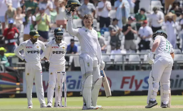 South Africa's Ryan Rickelton, center, celebrates his 100 runs during the second test match between South Africa and Pakistan in Cape Town, South Africa, Friday, Jan. 3, 2025. (AP Photo/Halden Krog)