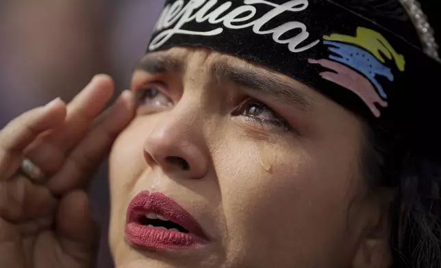 A woman cries during a protest by opponents of Venezuelan President Nicolas Maduro the day before his inauguration for a third term, in Bogota, Colombia, Thursday, Jan. 9, 2025. (AP Photo/Ivan Valencia)