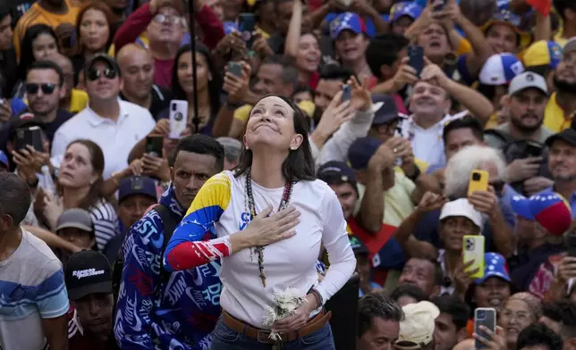 Venezuelan opposition leader Maria Corina Machado addresses supporters at a protest against President Nicolas Maduro in Caracas, Venezuela, Thursday, Jan. 9, 2025, the day before his inauguration for a third term. (AP Photo/Ariana Cubillos)