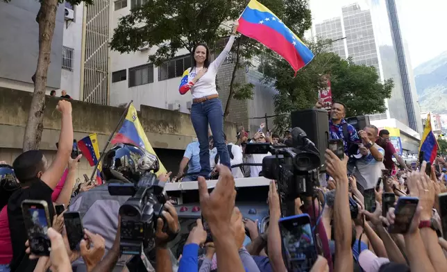 Venezuelan opposition leader Maria Corina Machado addresses supporters during a protest against President Nicolas Maduro the day before his inauguration for a third term in Caracas, Venezuela, Thursday, Jan. 9, 2025. (AP Photo/Matias Delacroix)