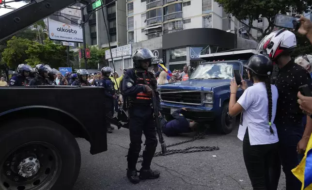 Police take possession of the truck from which opposition leader Maria Corina Machado addressed supporters at a protest in Caracas, Venezuela, Thursday, Jan. 9, 2025, the day before President Nicolas Maduro's inauguration for a third term. (AP Photo/Ariana Cubillos)