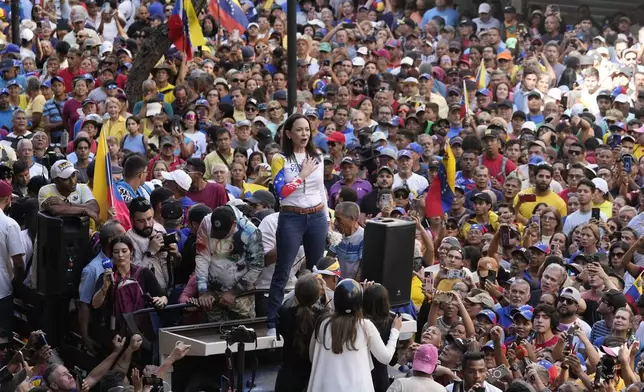 Opposition leader Maria Corina Machado stands before supporters during a protest against President Nicolas Maduro the day before his inauguration for a third term, in Caracas, Venezuela, Thursday, Jan. 9, 2025. (AP Photo/Ariana Cubillos)