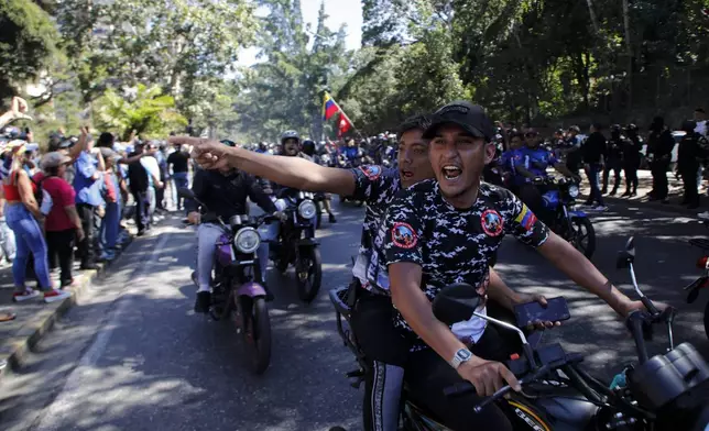 Government supporters shout at opponents of Venezuelan President Nicolas Maduro who are protesting the day before his inauguration for a third term in Caracas, Venezuela, Thursday, Jan. 9, 2025. (AP Photo/Cristian Hernandez)