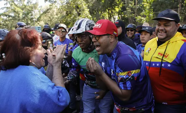 Government supporters, right, argue with an opponent of Venezuelan President Nicolas Maduro during an opposition protest the day before his inauguration for a third term in Caracas, Venezuela, Thursday, Jan. 9, 2025. (AP Photo/Cristian Hernandez)