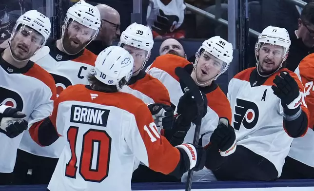 Philadelphia Flyers right wing Bobby Brink (10) is congratulated by teammates after scoring in the first period of an NHL hockey game against the Columbus Blue Jackets Tuesday, Jan. 14, 2025, in Columbus, Ohio. (AP Photo/Sue Ogrocki)